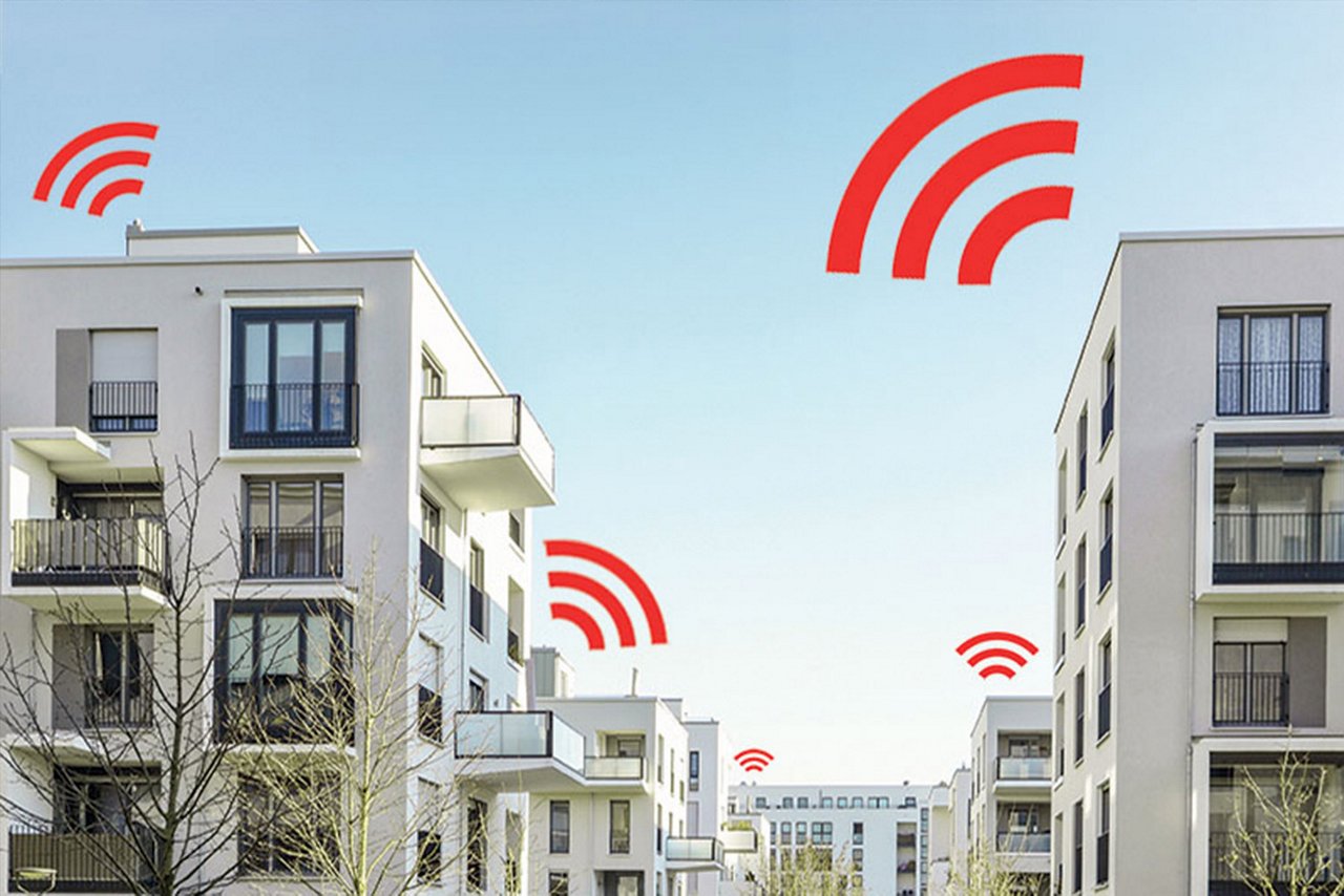 Rækker af hvide lejlighedsejendomme, hvor der over hver enkelt visuelt er der røde signaler. som indikation på måling.