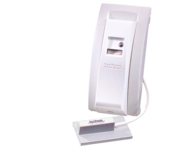 Repartidor de costes con sonda externa marca 'techem', de color blanco, con una pantalla digital. Esta colocado sobre una base blanca de la que sale la sonda para la medición de la temperatura